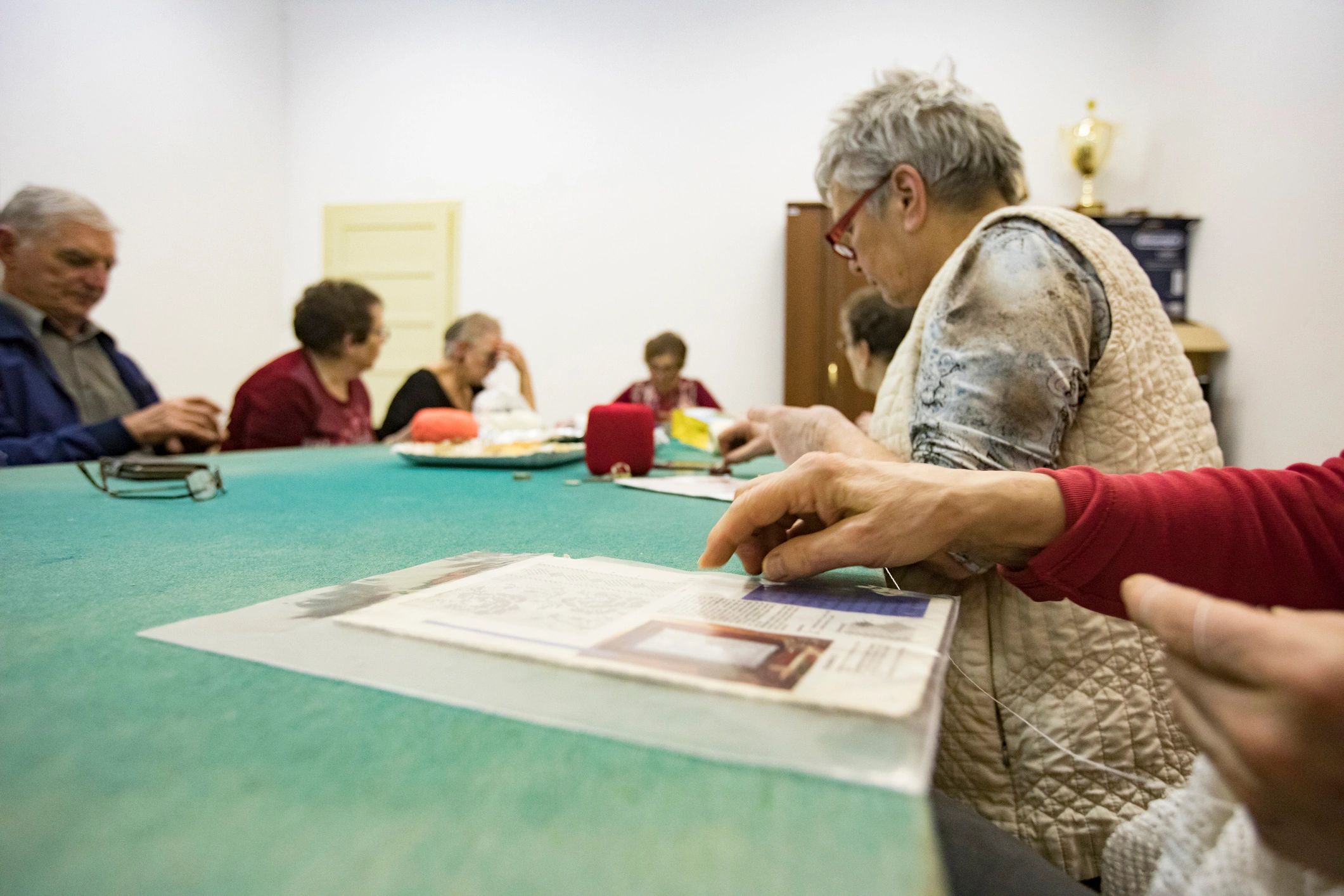 Friends gathered around a table enjoying a Mahjong-style game together
