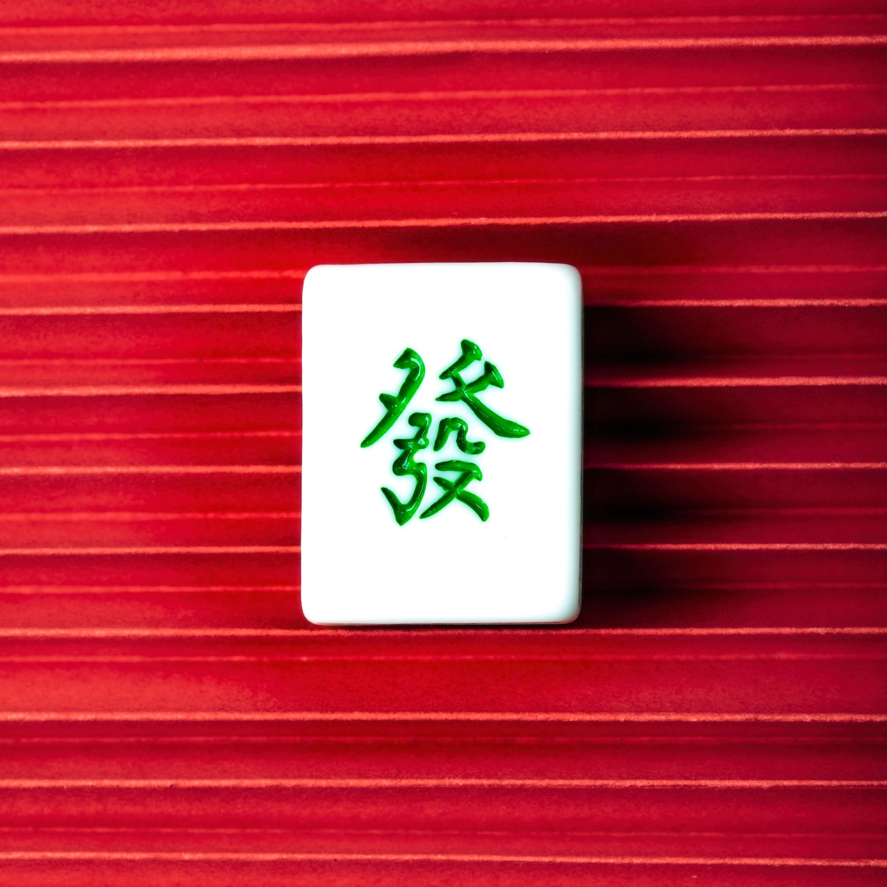 Mahjong tiles displayed on a red background