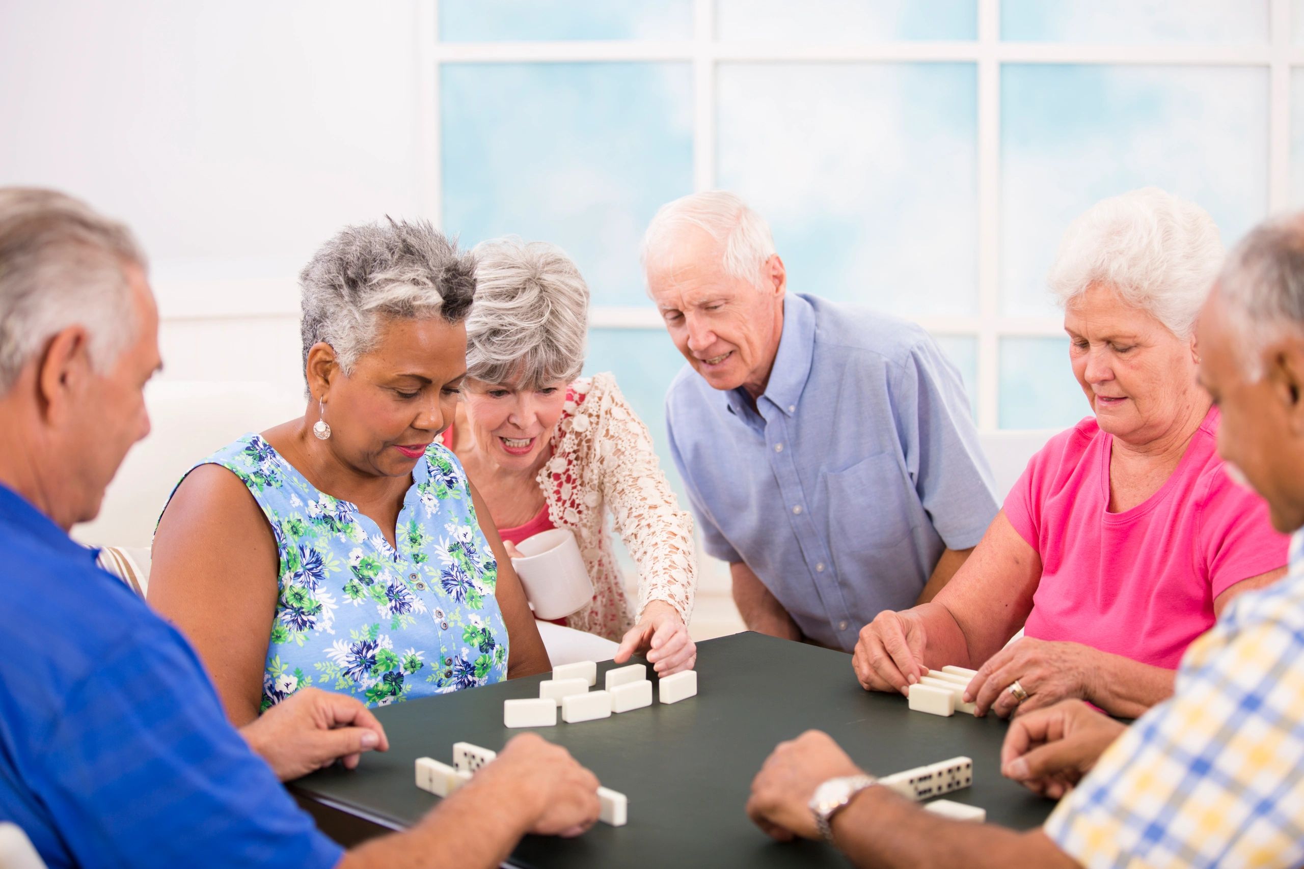 Happy customer playing a tabletop game with friends